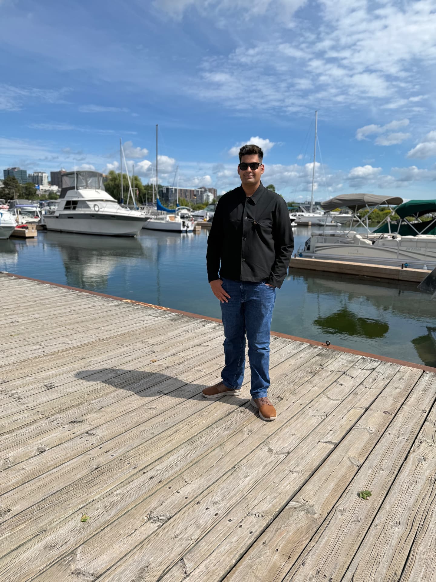 Asmar Naveed standing on a dock at the Barrie waterfront marina